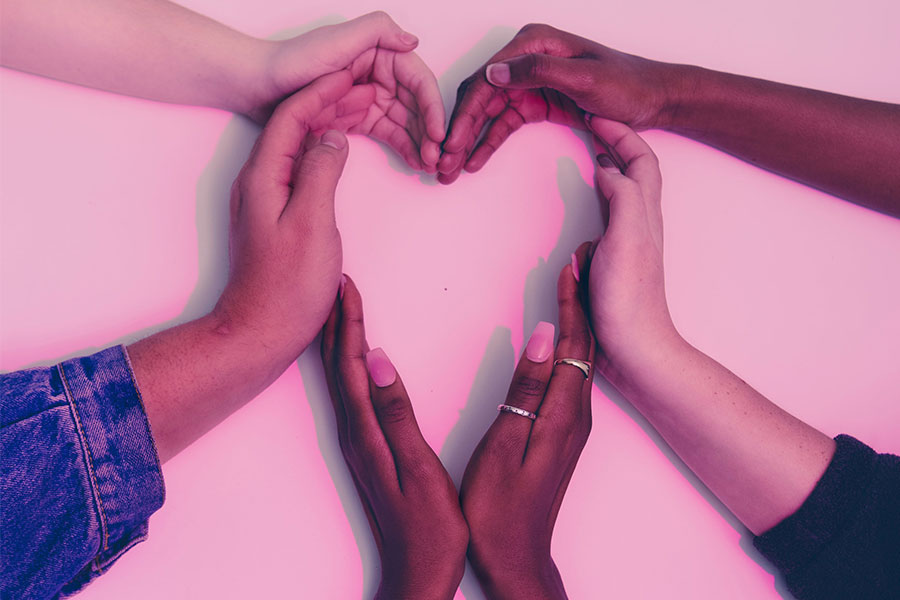 many connected hands creating the shape of a heart